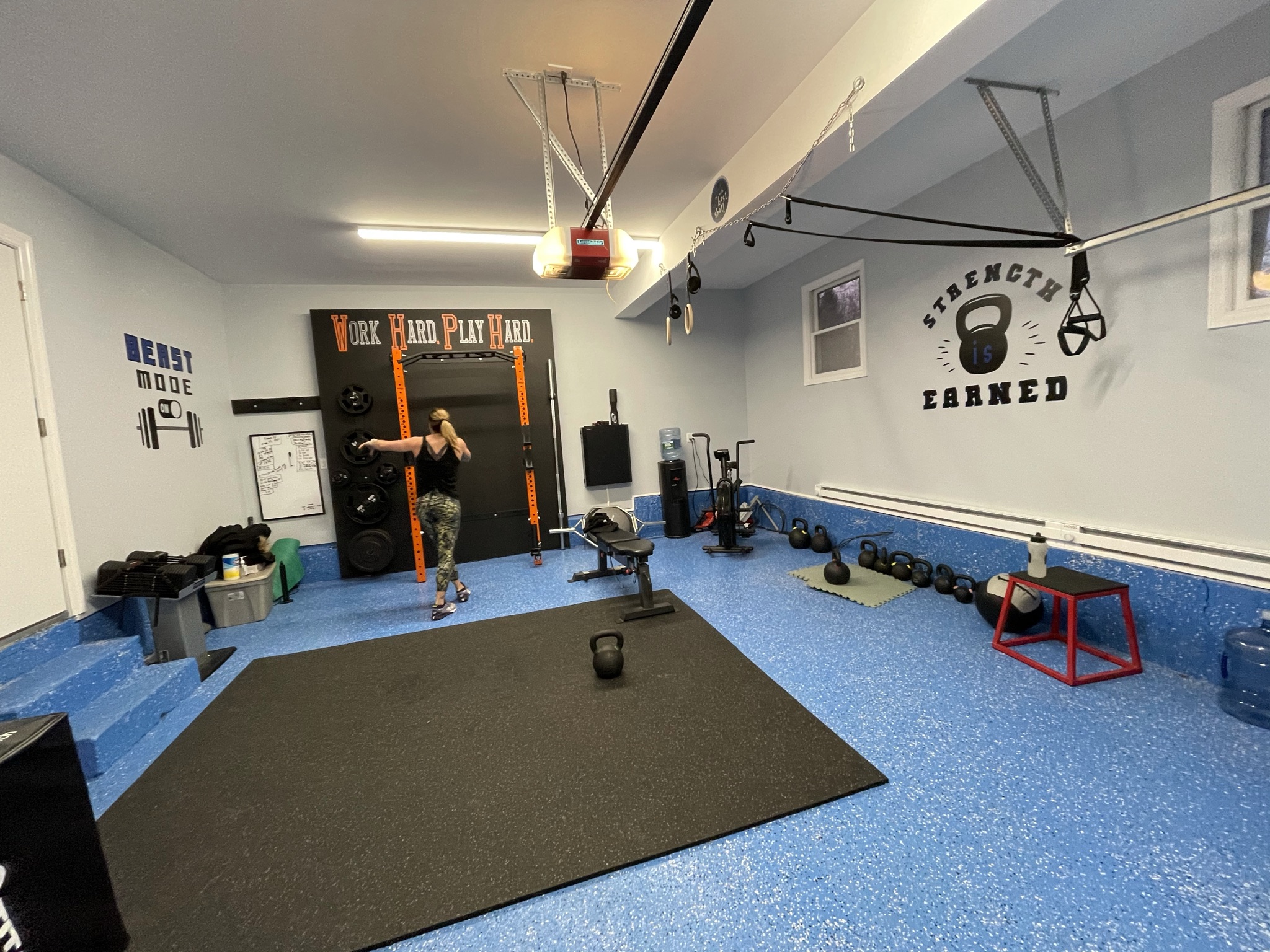 Dix Hills garage gym with strength equipment and open training space