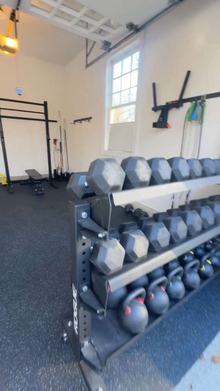 Dumbbell rack and medicine balls in the Oyster Bay Cove home gym